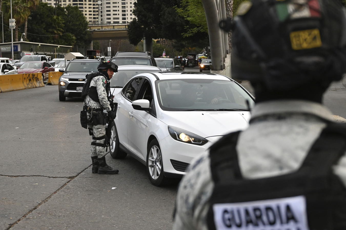 Mexican guard checking car at the border