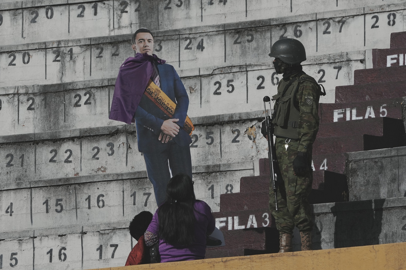 A cutout of President Daniel Noboa and a member of Ecuador's armed forces. (AP)