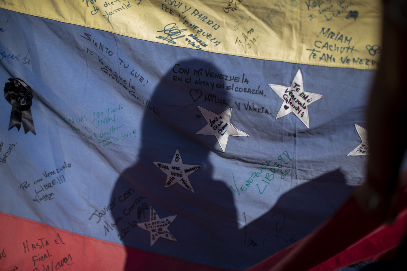 Silhouette on a Venezuelan flag at a voting center in Madrid, Spain. (AP)