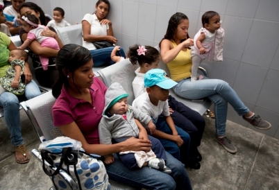 Venezuelan women in a waiting room with chidlren. (Associated Press)