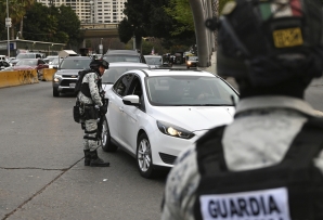 Mexican guard checking car at the border