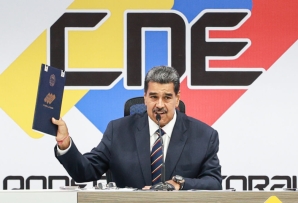 Venezuelan President Nicolás Maduro holds his certificate of election victory in Caracas on July 29.