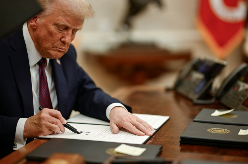 President Donald Trump signing executive orders.