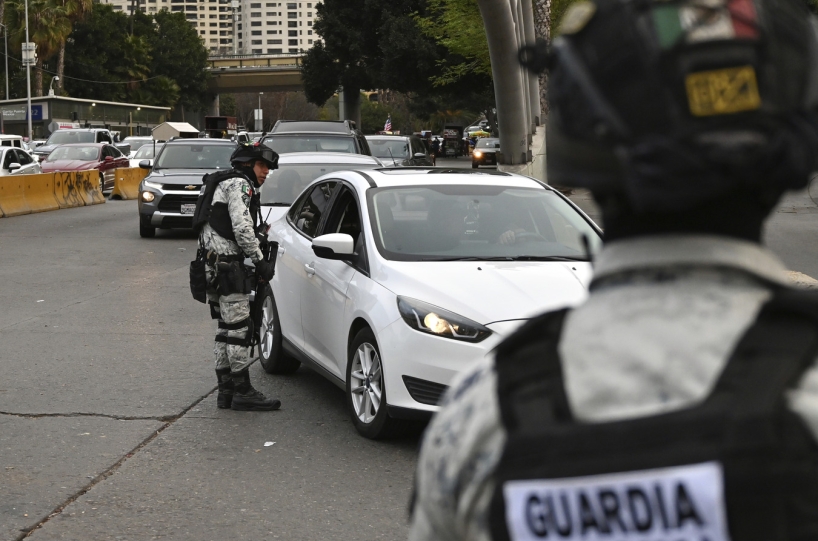 Mexican guard checking car at the border