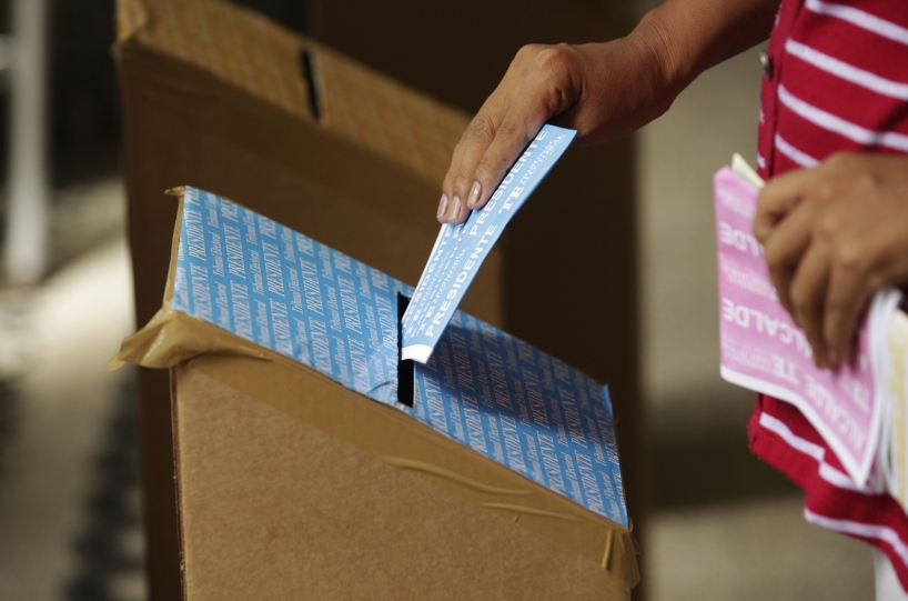 A woman casts her vote